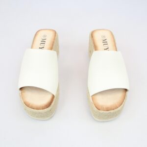 Wide strap wedge slide sandals with open toe design.