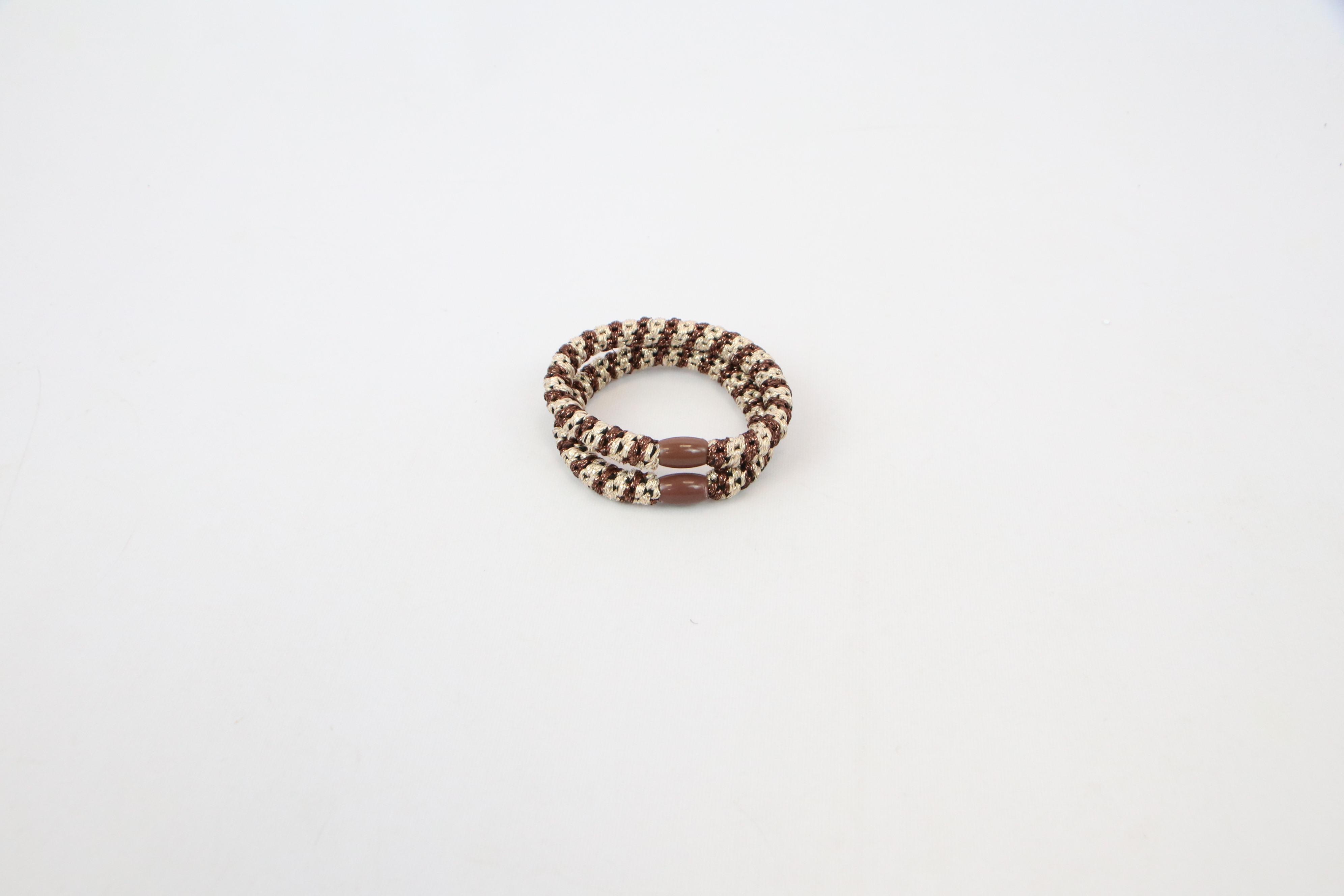 Double loop textured elastic hair tie set with soft stretch design for everyday hair styling.