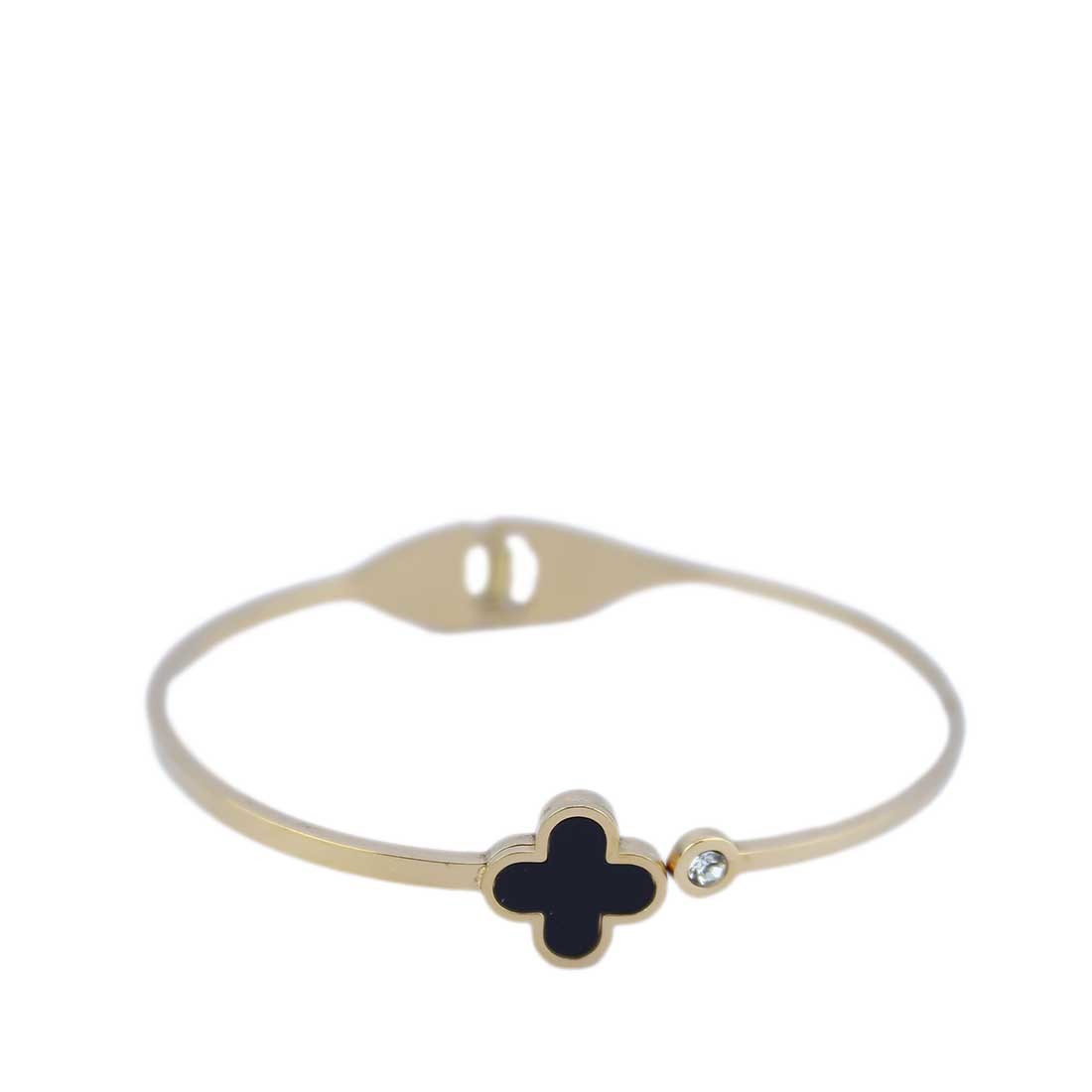 A hinged bangle with a central, four-leaf clover charm.