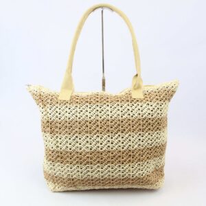 Woven beach bag with braided handles and tassel charm, ideal for summer outings.