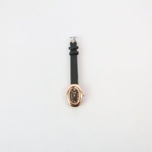 Elegant oval wrist watch with Roman numeral dial and textured strap for everyday wear.