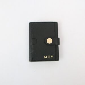 Compact card holder wallet with snap button closure and multiple card slots.