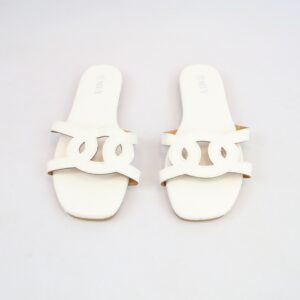 Flat slide sandals with textured finish and cut-out strap detail.