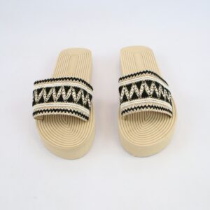 Flat slide sandals with woven strap detailing and decorative trim design.