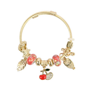 Gold charm bracelet with red beads
