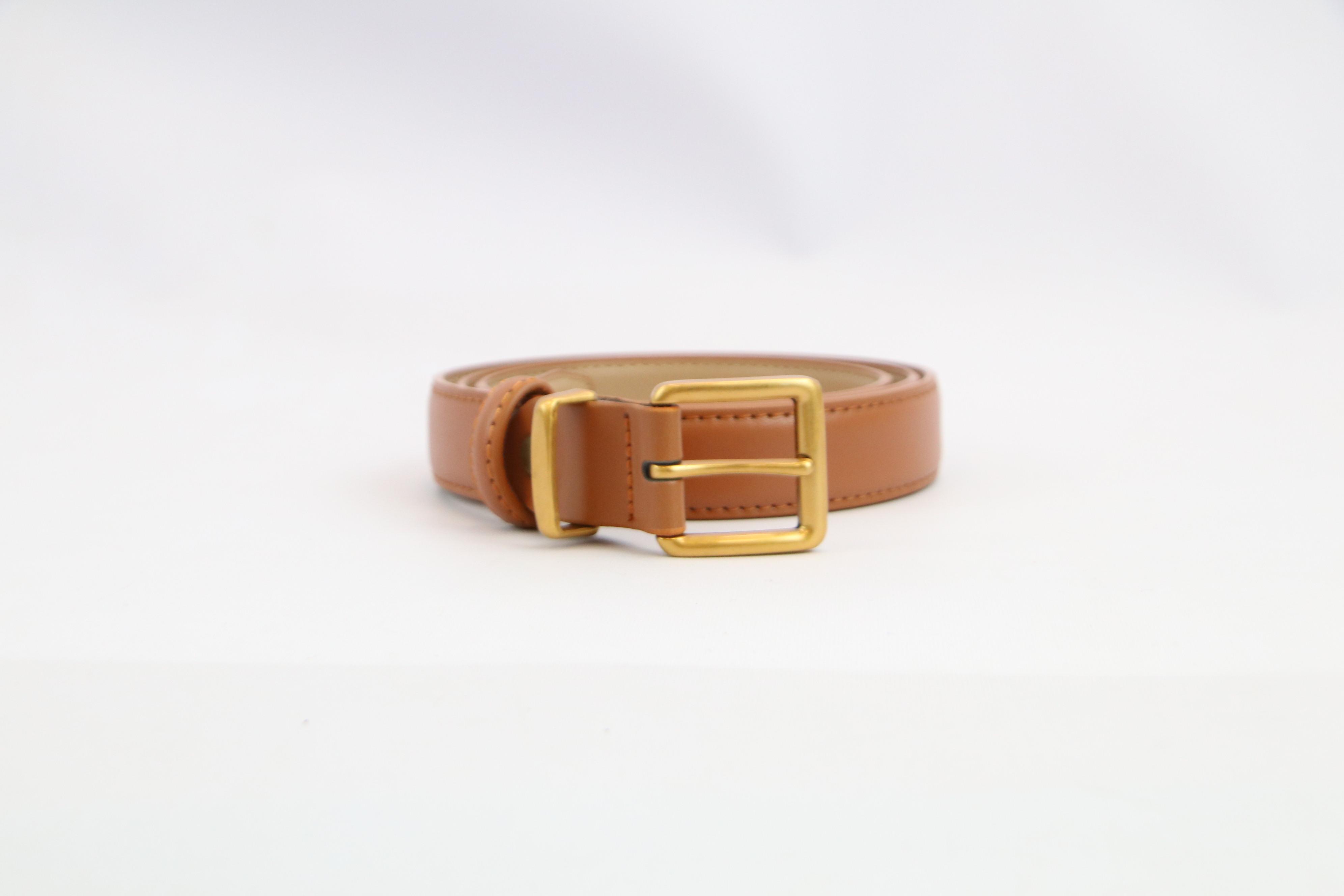 Classic womens belt with smooth finish and gold-tone buckle for everyday styling.