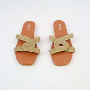 Flat sandals with crossover strap design and rhinestone detailing.