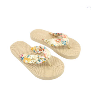 Flat sandals with rope-textured sole and fabric bow strap detail.