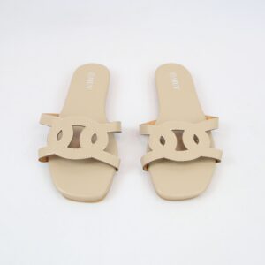 Flat slide sandals with textured finish and cut-out strap detail.