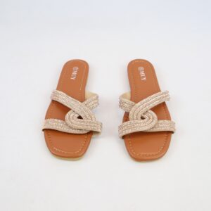 Flat sandals with crossover strap design and rhinestone detailing.